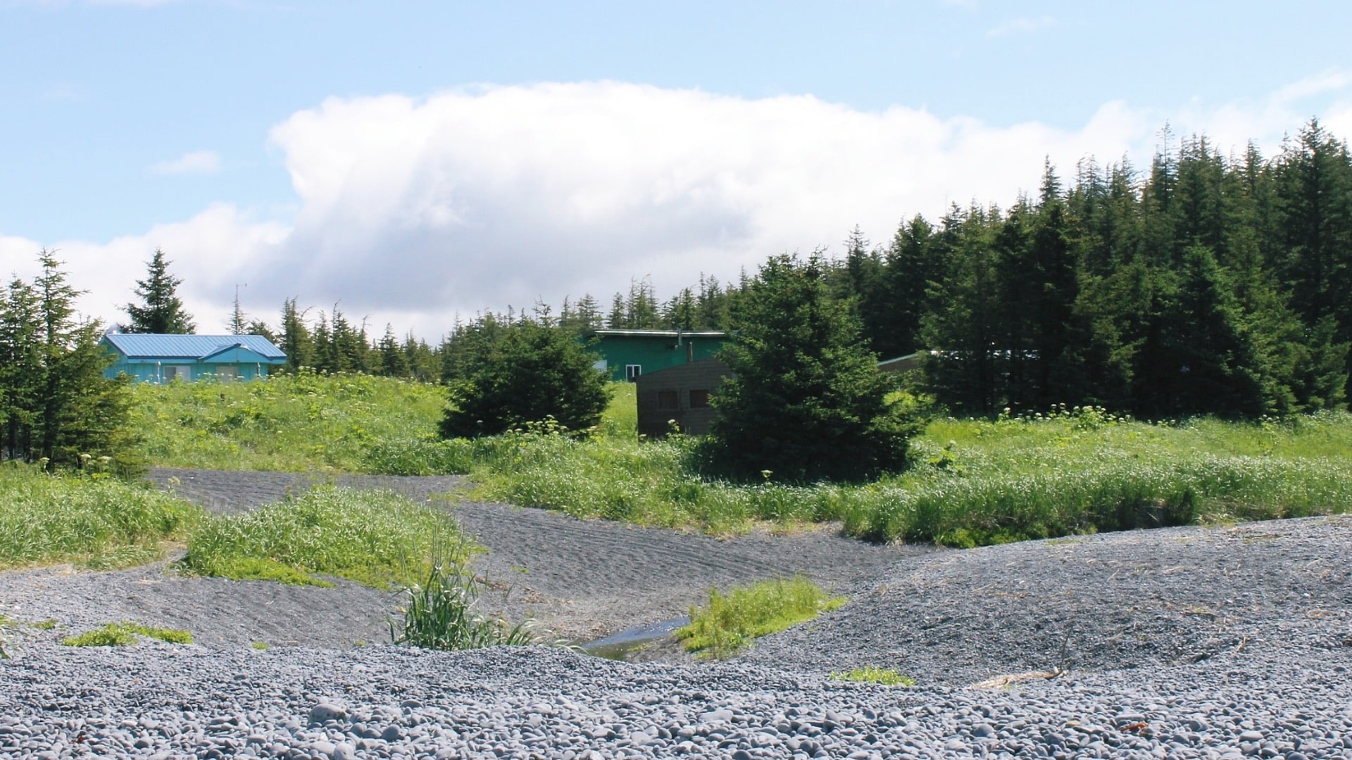 Hills with gravel and small buildings and trees