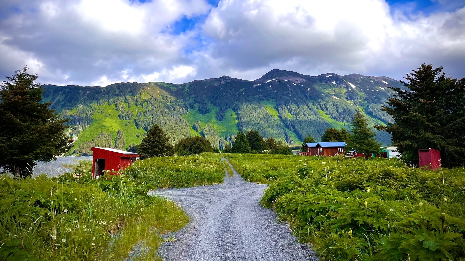 Narrow gravel road with buildings on the side