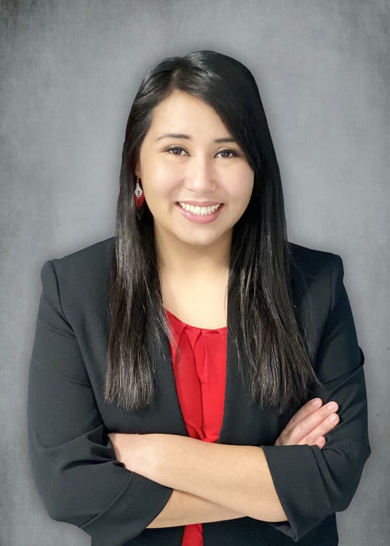 Woman with a black coat and red shirt smiling